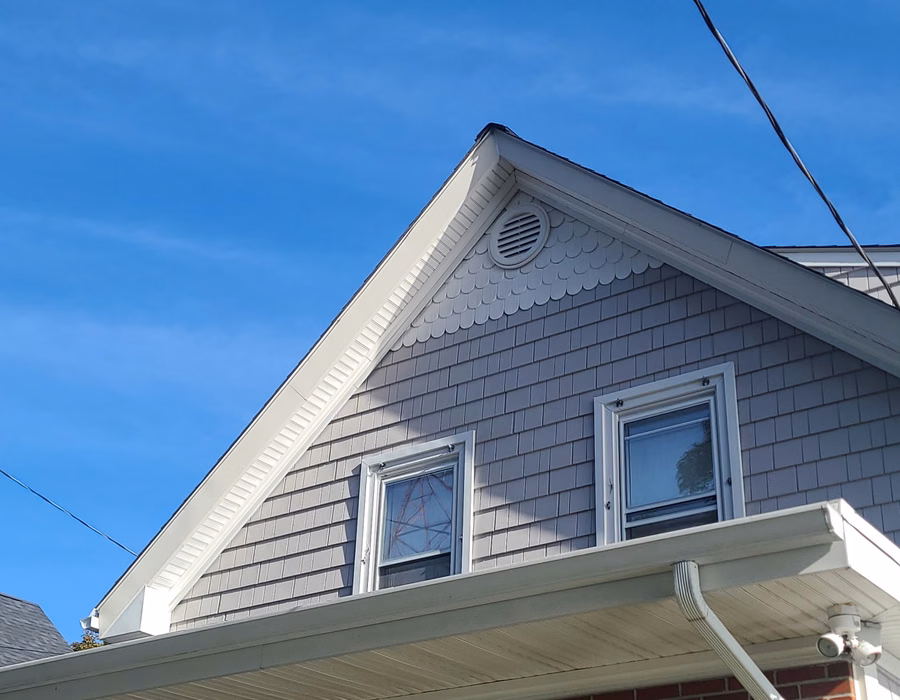 Gable end with new cedar shingles, trim, and gutters