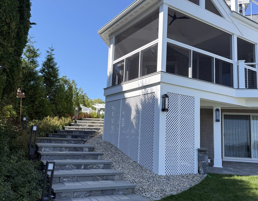 Completed residential renovation with screened porch and stone landscaping