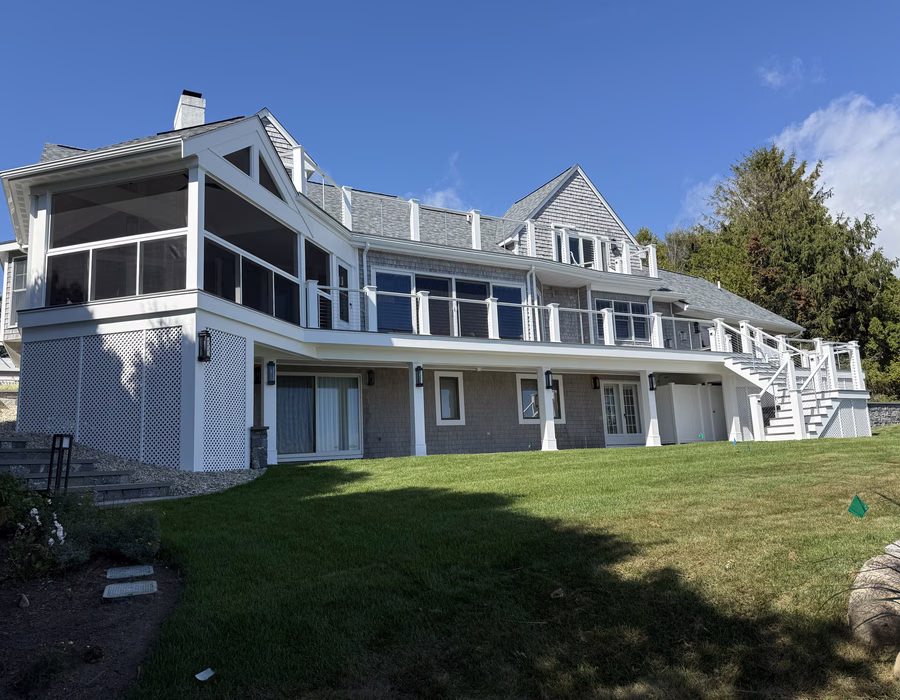 Renovated shingle-style waterfront home with screened porch and wraparound decks