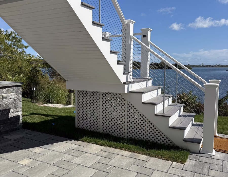 Custom-built staircase with white risers and cable railing